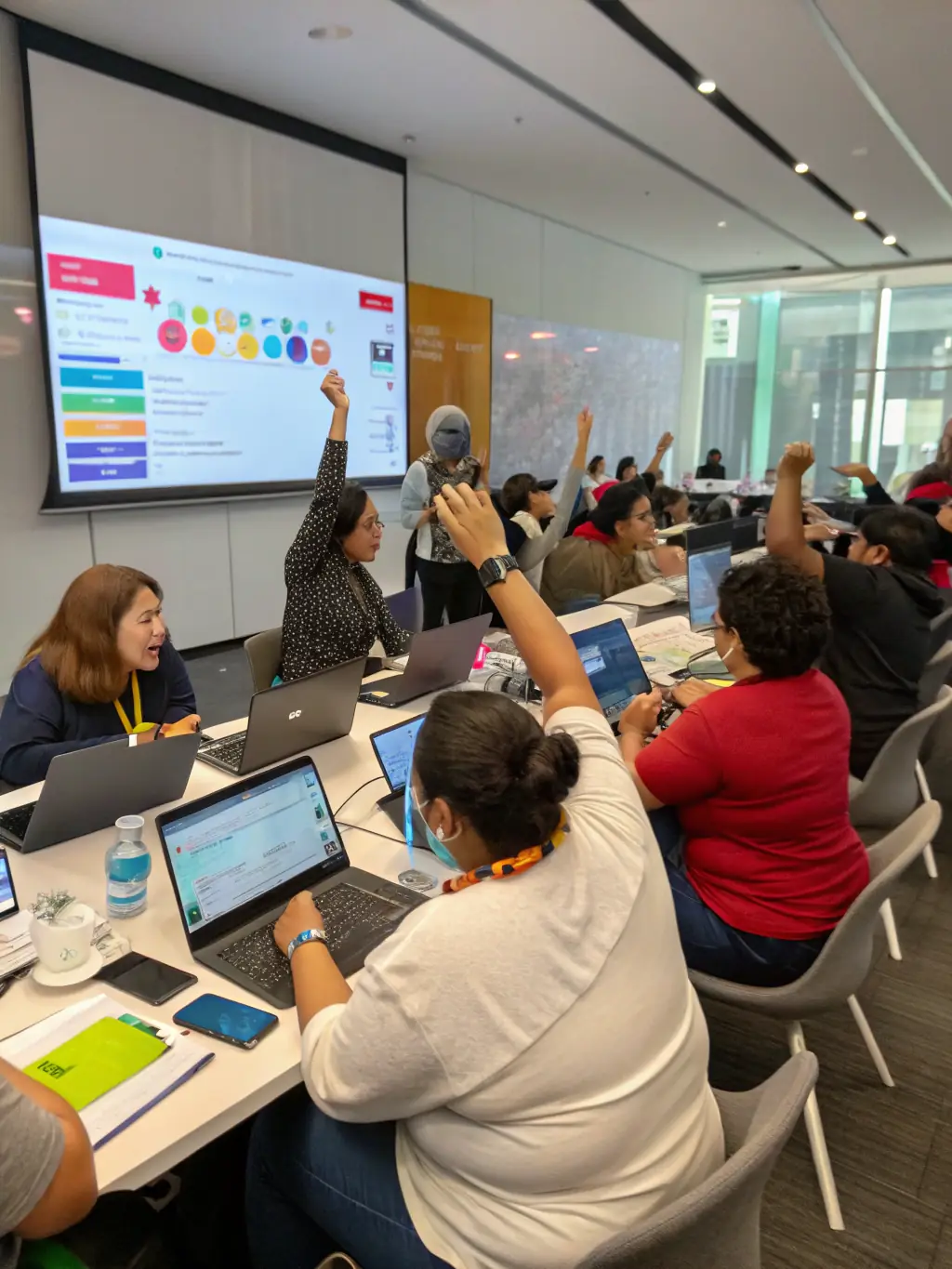 A diverse group of nonprofit staff members are collaboratively brainstorming ideas during a capacity building training session, with laptops and notebooks scattered around a table, fostering an atmosphere of learning and innovation.