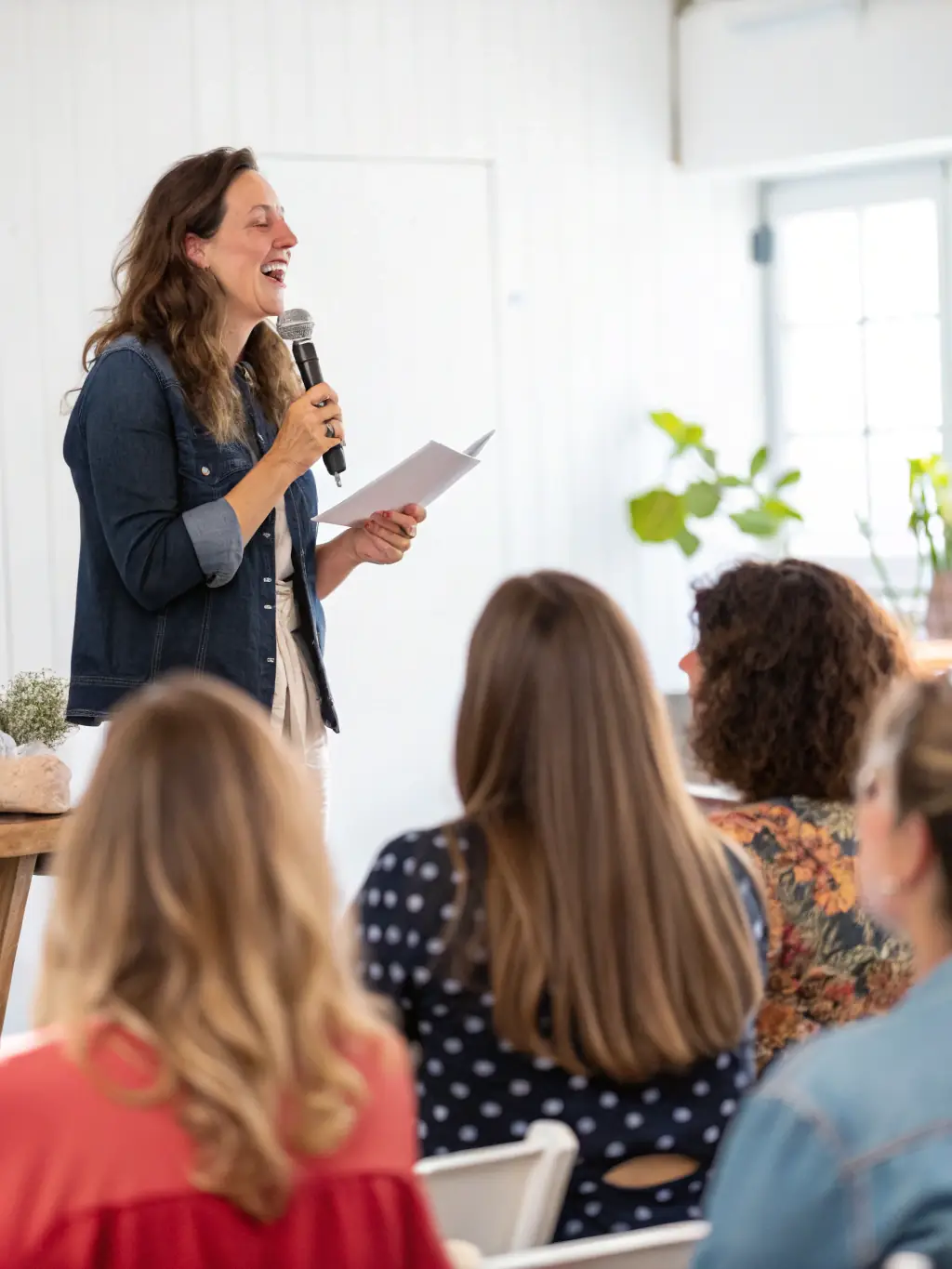 A dynamic speaker is presenting at a nonprofit workshop, engaging the audience with practical fundraising strategies and real-world examples, while participants actively take notes and ask questions.